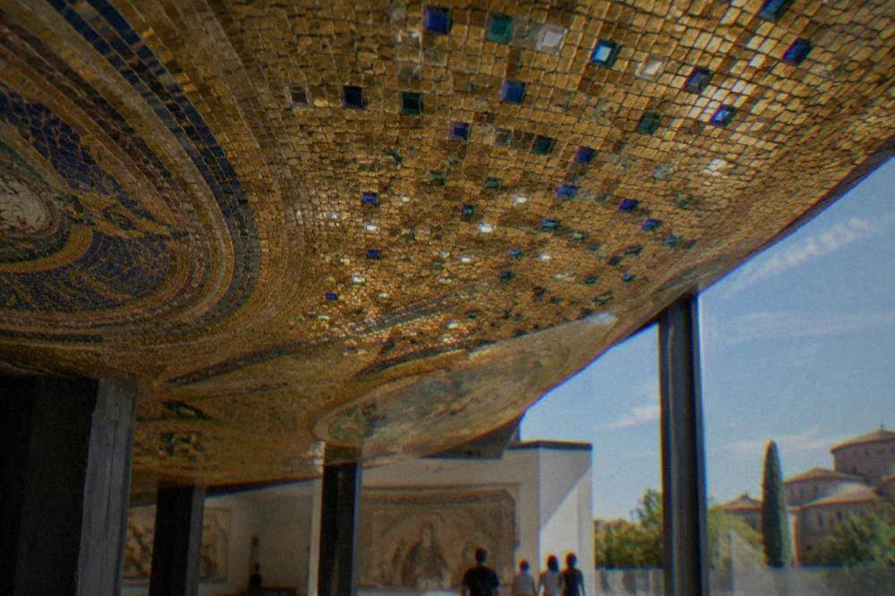 A gold ground mosaic ceiling seen from below, cubes of glass catching light at different angles