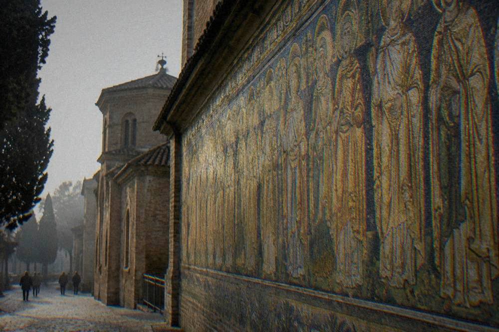 Procession of gold mosaic figures along the wall of a Ravenna basilica