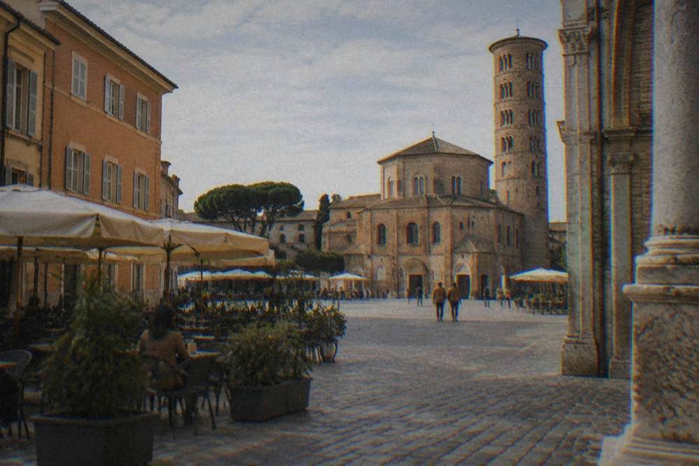 Piazza with cafes and historic buildings in central Ravenna