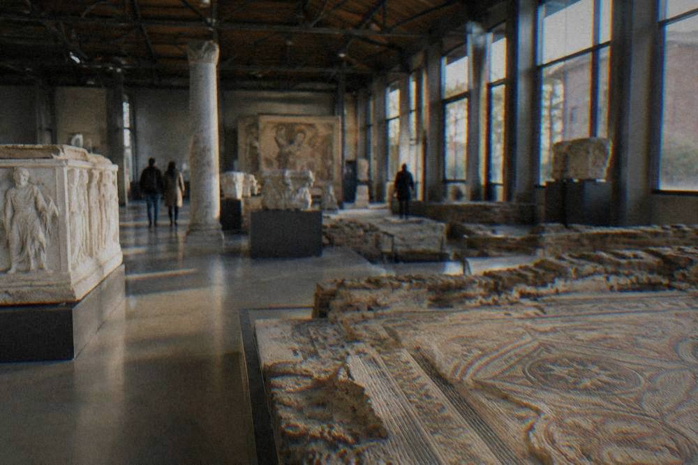 Interior of a large industrial museum hall with archaeological displays