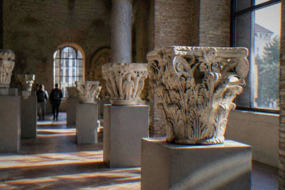 Ancient carved stone capitals displayed in a museum gallery