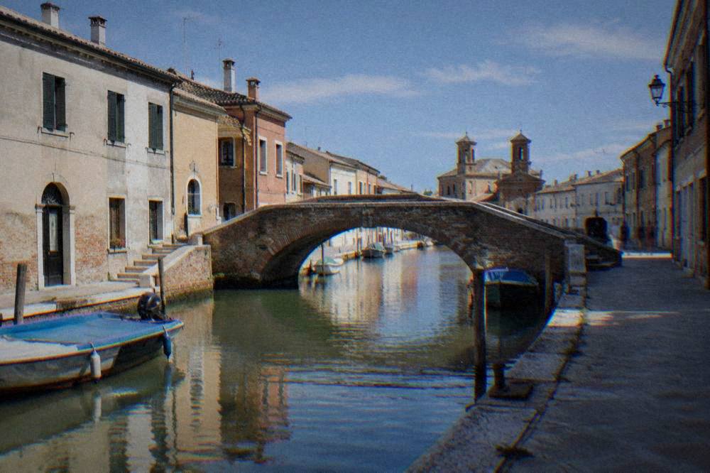 Canal street with old bridges in a small lagoon town near Ravenna