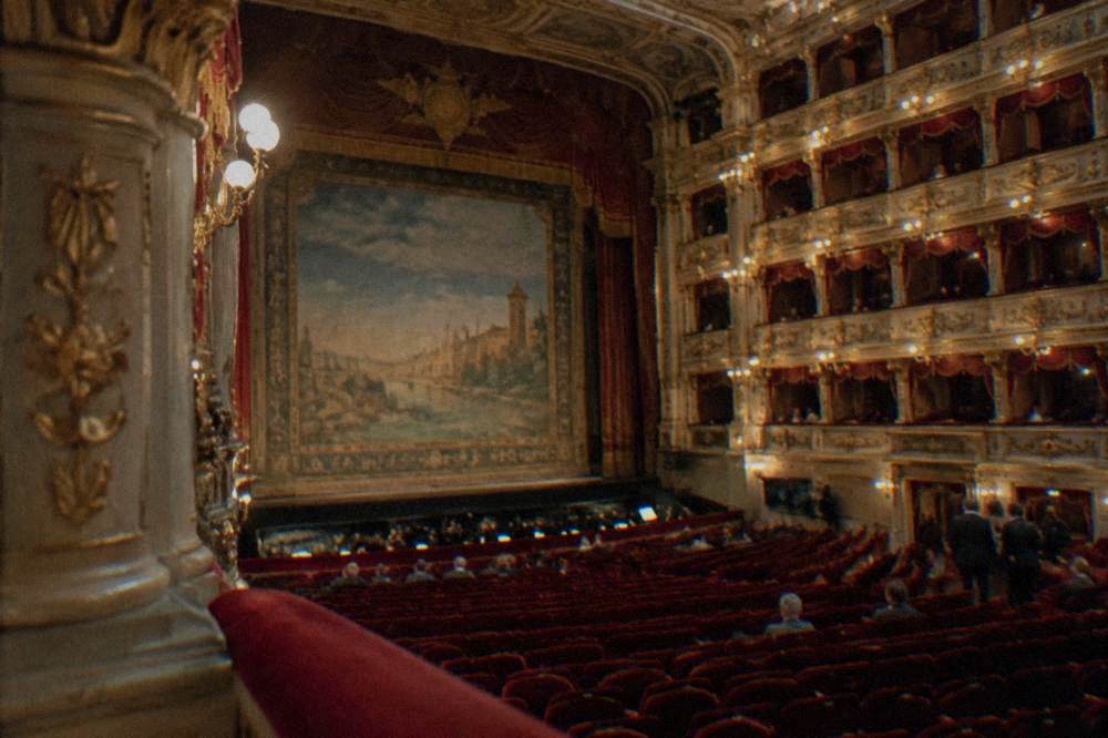 The ornate interior of an Italian opera house before a performance
