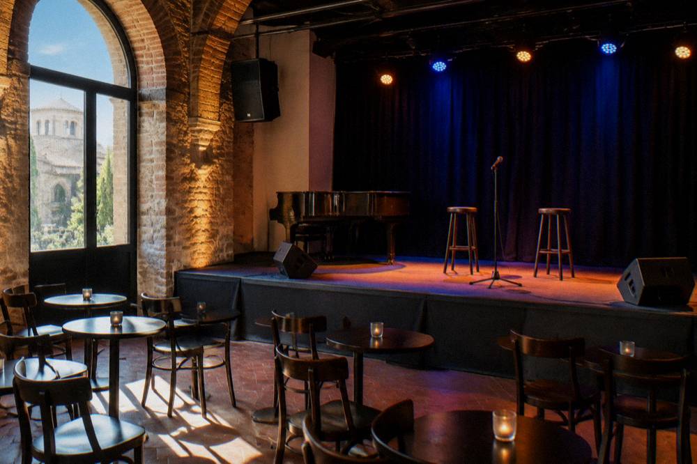 A small music venue interior with a stage lit for a live show