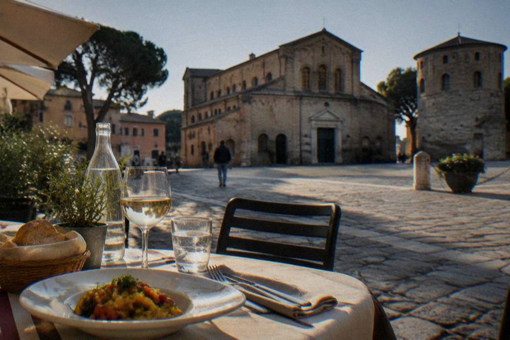 A table set for lunch outside a small restaurant in an Italian square