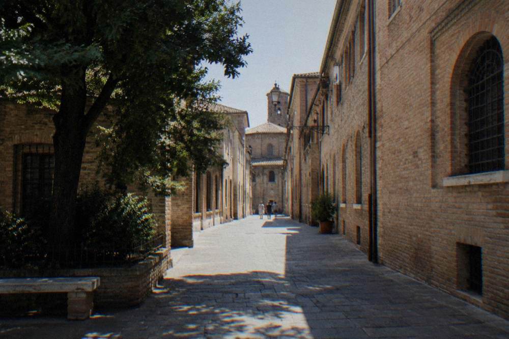 A quiet pedestrian street in central Ravenna lined with old brick buildings