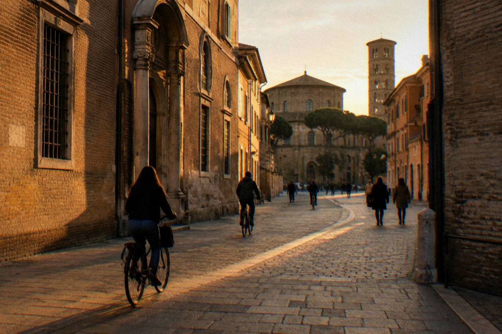 Bicycles and pedestrians on a flat street in central Ravenna