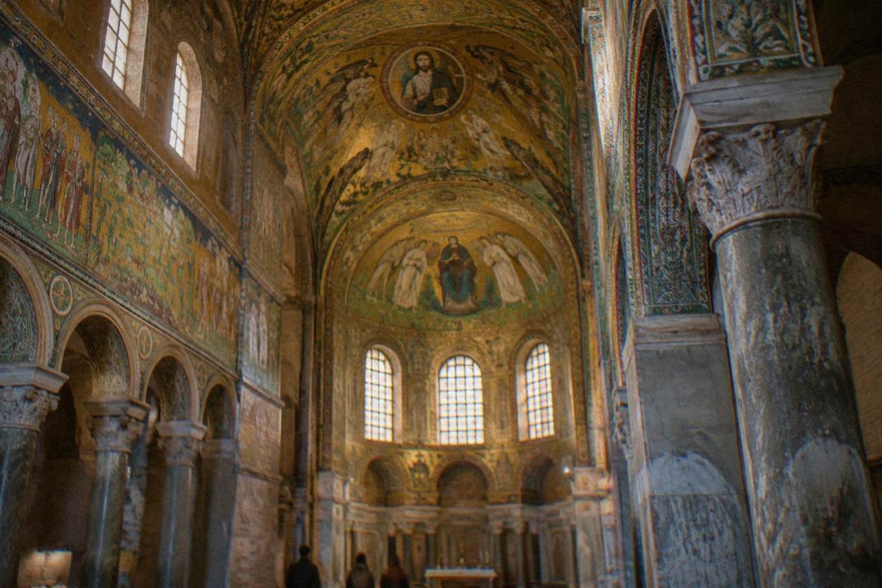 Golden Byzantine mosaics covering the vault of an ancient church interior in Ravenna