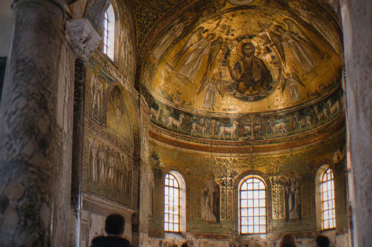 Golden Byzantine mosaics inside a domed early Christian monument in Ravenna