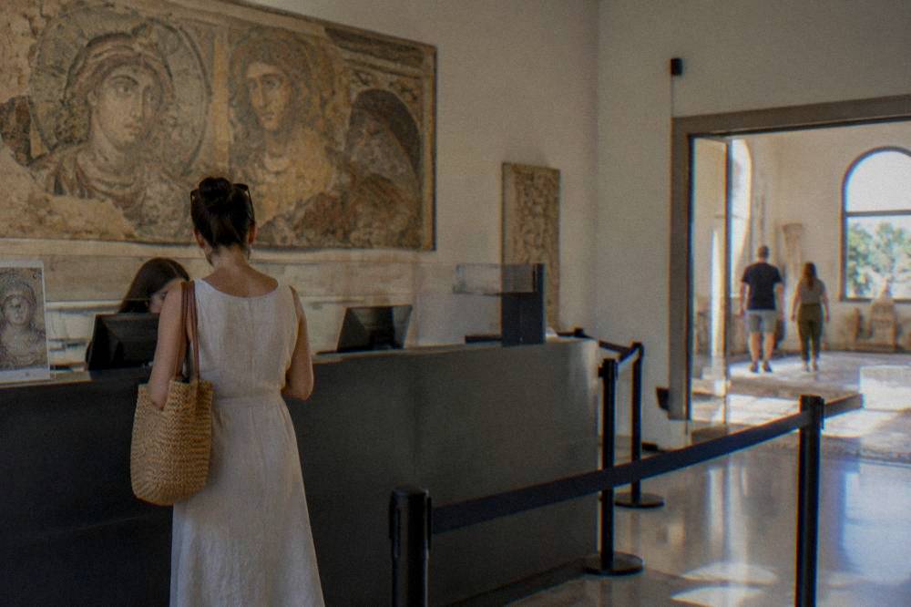 A ticket office counter in a museum with a visitor buying entry