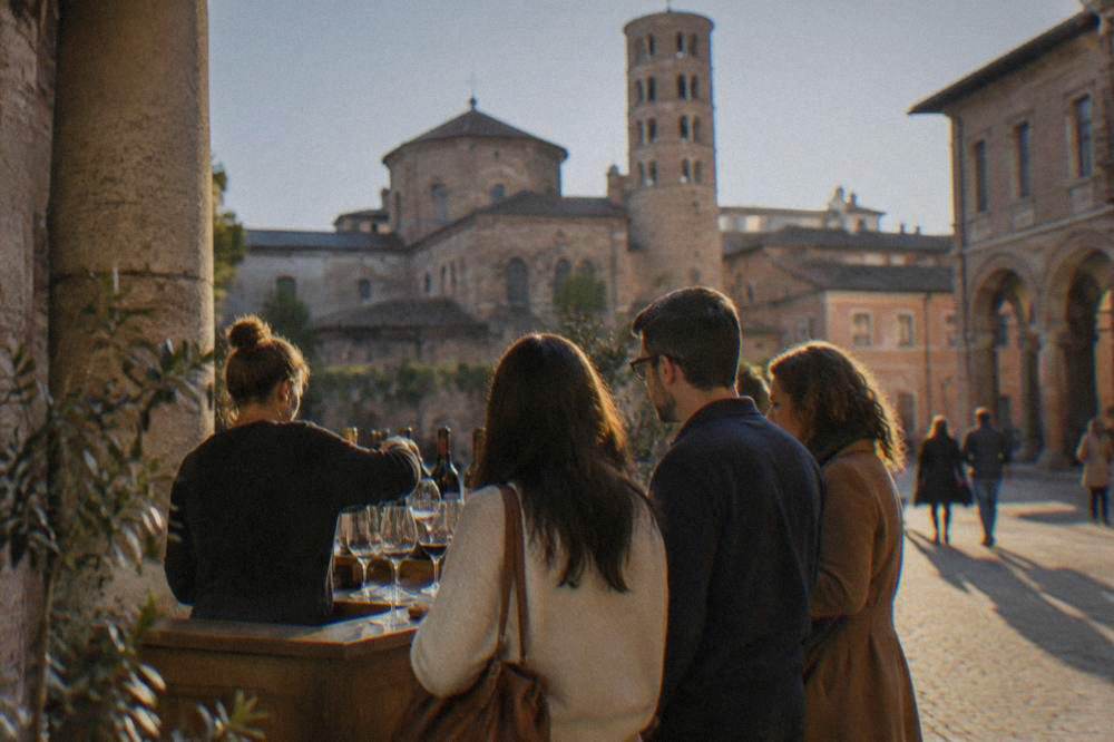 A small group standing at a wine counter during a guided tasting