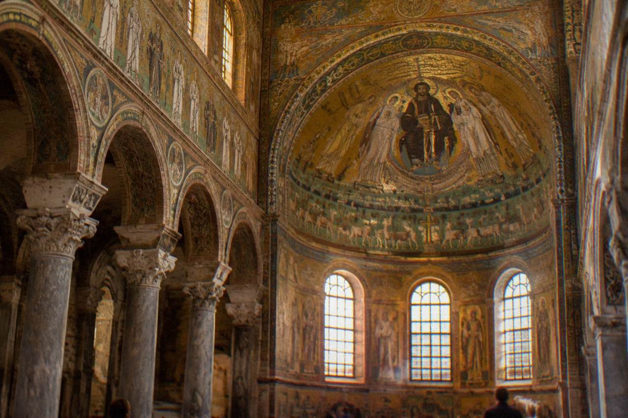 Golden Byzantine mosaics covering the vault of an ancient Ravenna church interior
