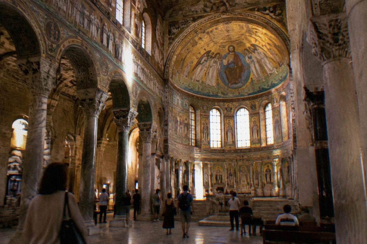 Golden mosaic interior of a Ravenna basilica lit by warm light