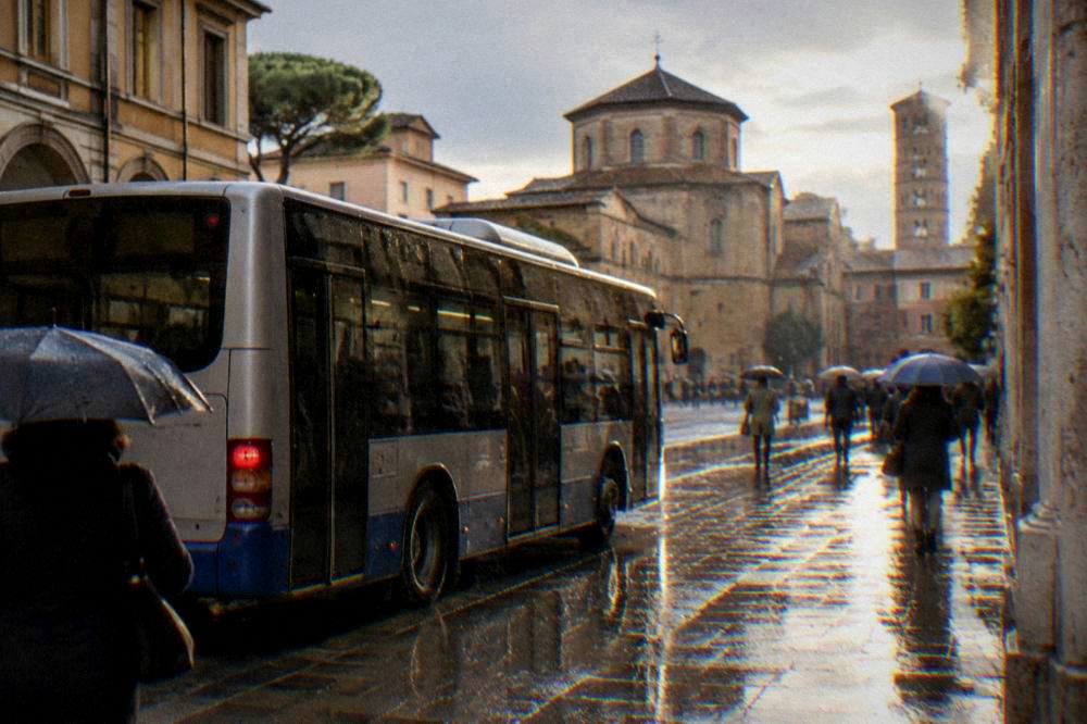A city bus stopped on a rainy street in Ravenna with wet pavement and people with umbrellas