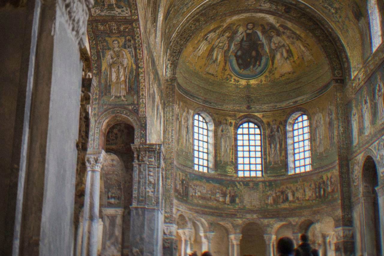 Golden mosaic interior of an early Christian church in Ravenna lit by soft daylight