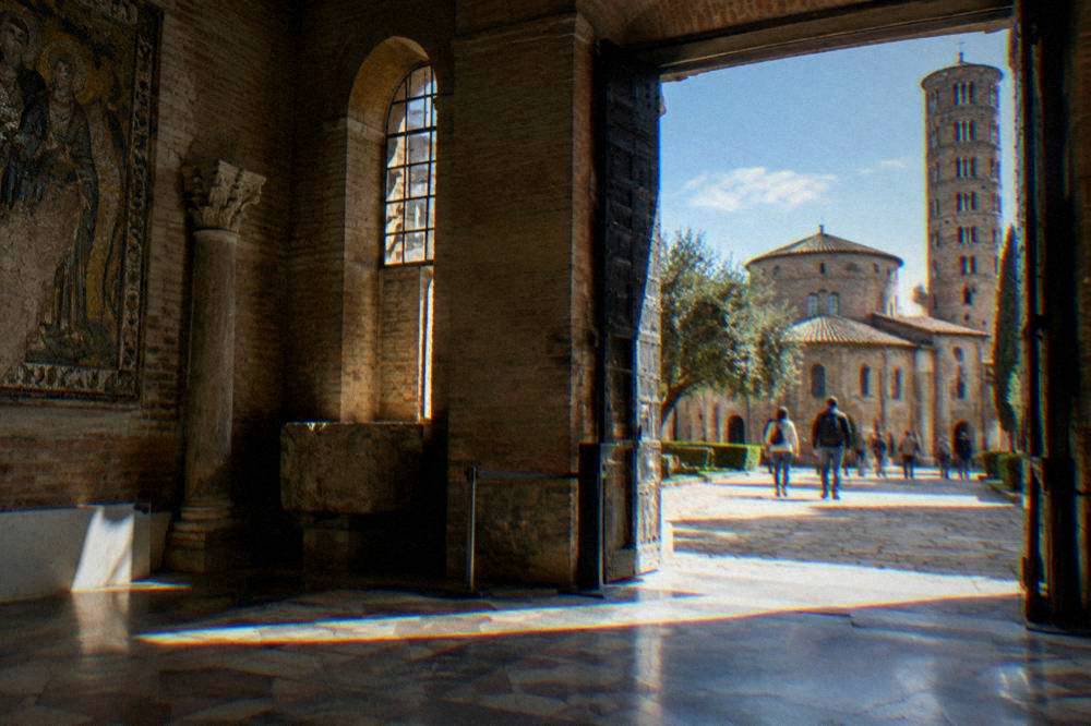 Ancient brick mausoleum with a massive stone dome under a clear sky