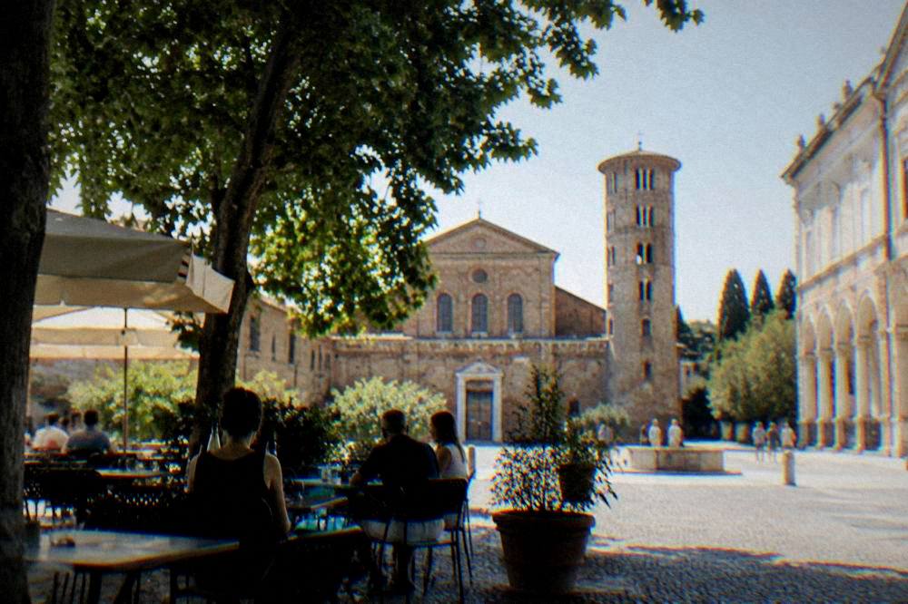 Evening light on a Ravenna piazza with the silhouette of a brick bell tower