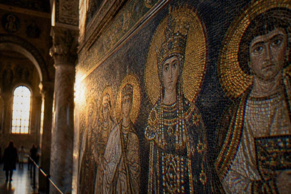 Detail of a Byzantine mosaic wall with figures in gold and blue glass tesserae
